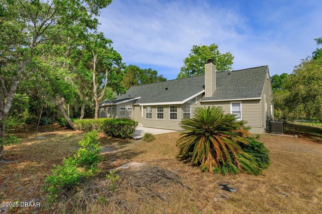 640 Old Treeline Trl, Deland, FL 32724 - rear view of property with a patio, central AC unit, a chimney, and roof with shingles
