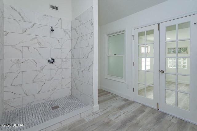 640 Old Treeline Trl, Deland, FL 32724 - bathroom featuring wood finished floors, french doors, and tiled shower