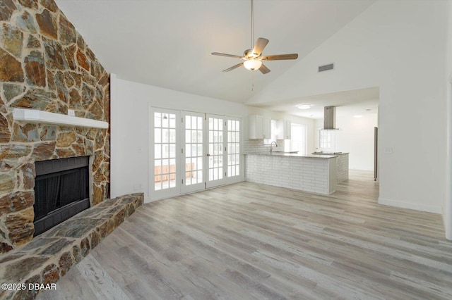 640 Old Treeline Trl, Deland, FL 32724 - unfurnished living room with light wood-type flooring, ceiling fan, high vaulted ceiling, a fireplace, and a sink
