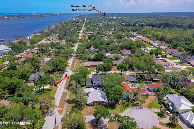 drone / aerial view with a water view and a residential view