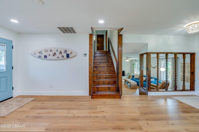 entrance foyer with stairs, recessed lighting, visible vents, and wood finished floors