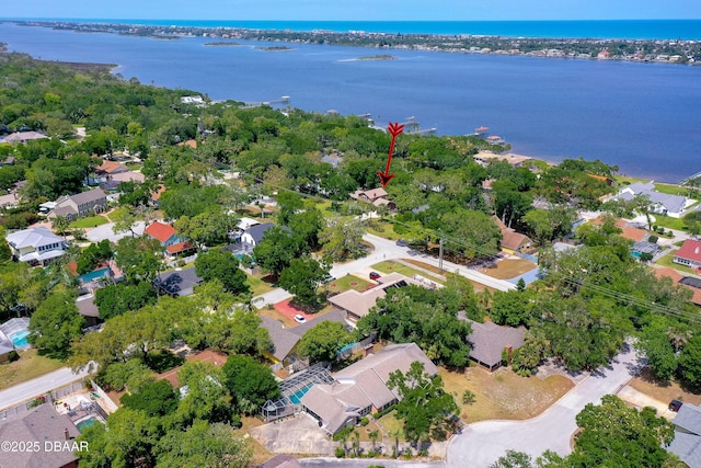 birds eye view of property with a water view and a residential view