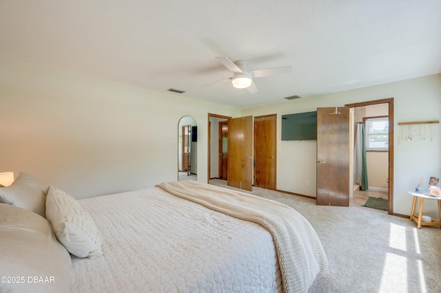 bedroom with light colored carpet, baseboards, ceiling fan, and visible vents