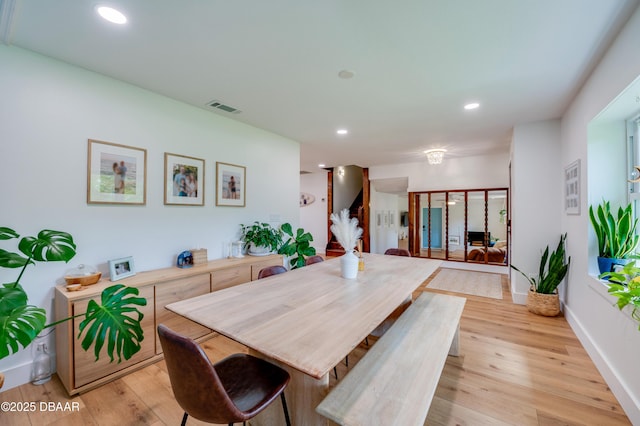 dining room featuring baseboards, recessed lighting, light wood finished floors, and visible vents