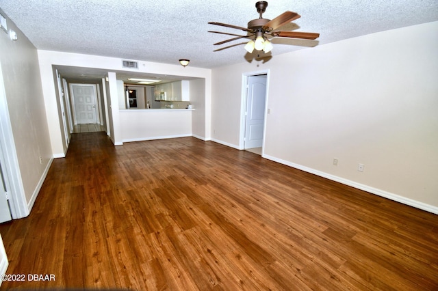 unfurnished living room featuring a textured ceiling, hardwood / wood-style flooring, and ceiling fan