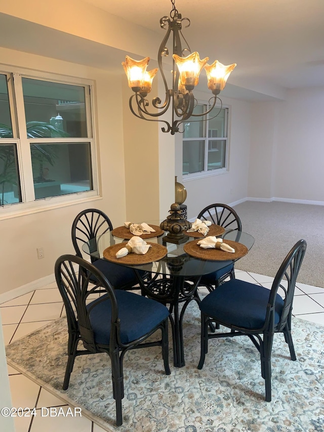 tiled dining room with a notable chandelier