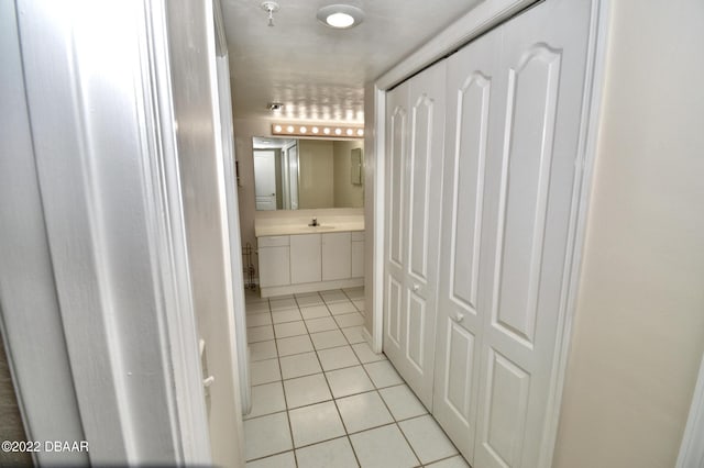 bathroom with tile patterned flooring and vanity