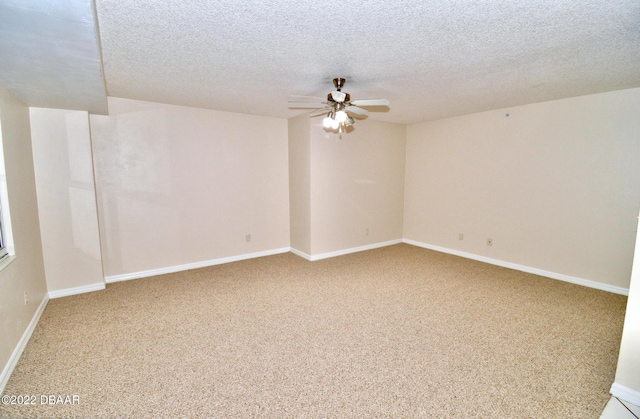 unfurnished room with carpet flooring, ceiling fan, and a textured ceiling