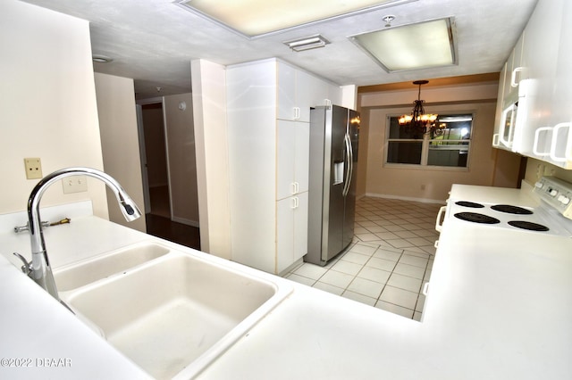 kitchen with white appliances, sink, decorative light fixtures, a chandelier, and light tile patterned flooring