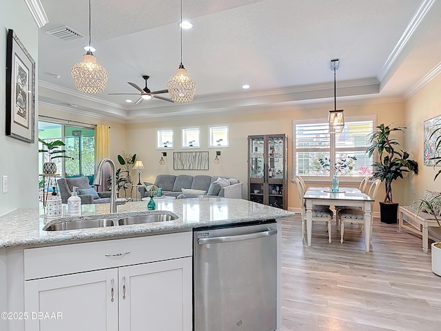 kitchen with visible vents, a sink, stainless steel dishwasher, a raised ceiling, and open floor plan