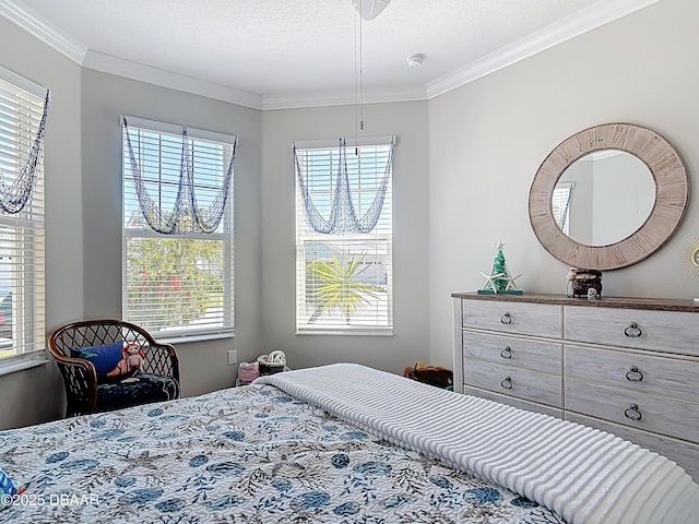 bedroom with multiple windows, a textured ceiling, and crown molding