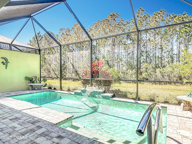 outdoor pool with glass enclosure and a patio