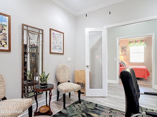 home office featuring french doors, baseboards, ornamental molding, and light wood finished floors