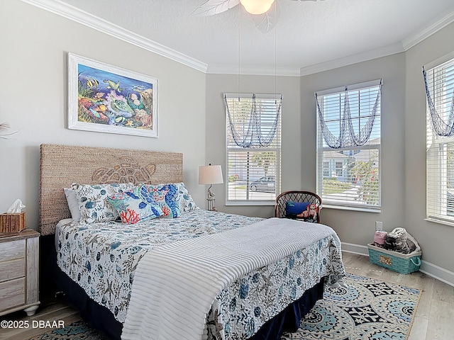 bedroom with multiple windows, wood finished floors, and ornamental molding