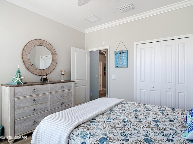 bedroom with visible vents, attic access, a closet, and crown molding