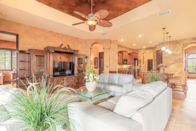 tiled living room featuring ceiling fan