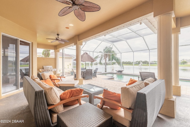 view of patio / terrace featuring a lanai, an outdoor living space, ceiling fan, a water view, and a fenced in pool