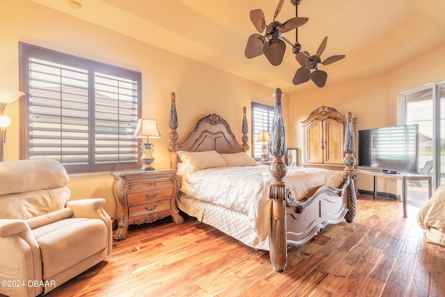 bedroom with ceiling fan, light wood-type flooring, and multiple windows