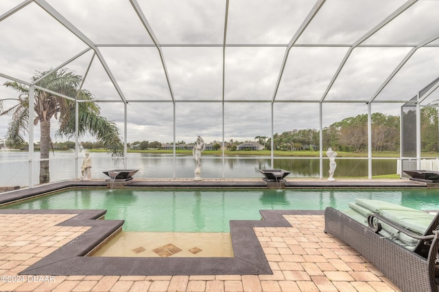 view of swimming pool featuring pool water feature, glass enclosure, a water view, and a patio