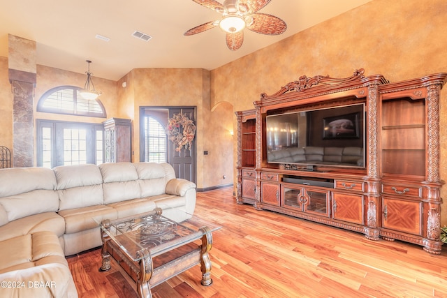 living room featuring ceiling fan and hardwood / wood-style floors