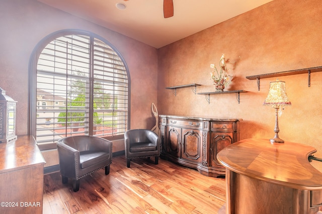 sitting room featuring ceiling fan and light wood-type flooring