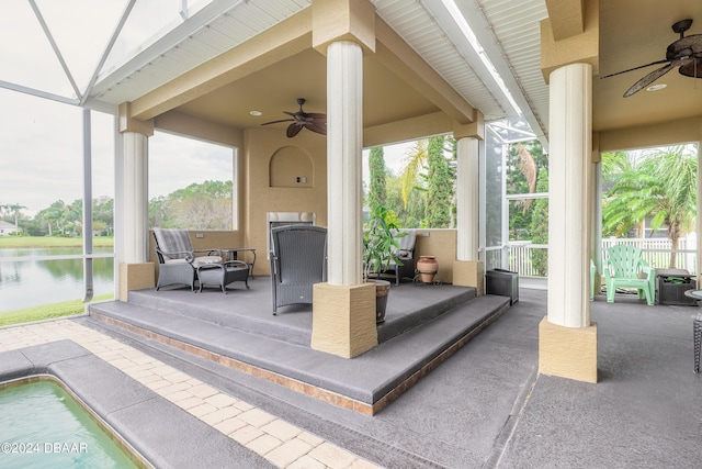 view of patio with ceiling fan and a water view