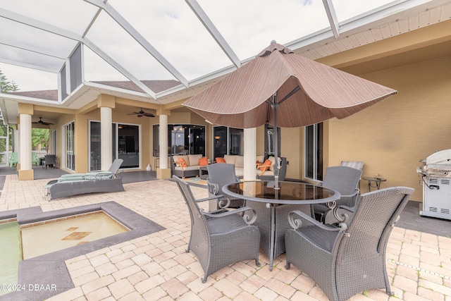 view of patio featuring glass enclosure, ceiling fan, outdoor lounge area, and a grill