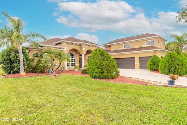 mediterranean / spanish-style house with a garage and a front lawn