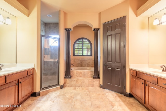 bathroom with vanity, separate shower and tub, and decorative columns