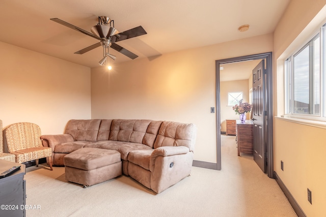 carpeted living room featuring plenty of natural light and ceiling fan