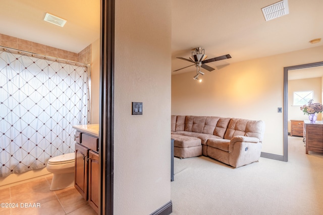 living room featuring ceiling fan and light carpet