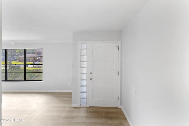 entrance foyer with baseboards and light wood-style flooring