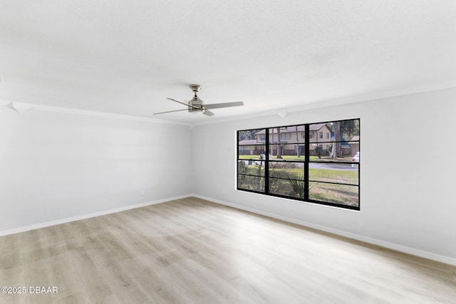 unfurnished room with baseboards, ornamental molding, light wood-style flooring, and ceiling fan