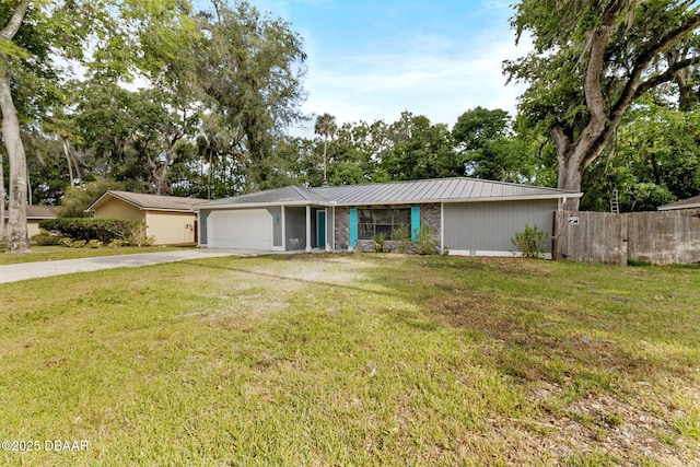 ranch-style house with fence, a front lawn, driveway, and a garage