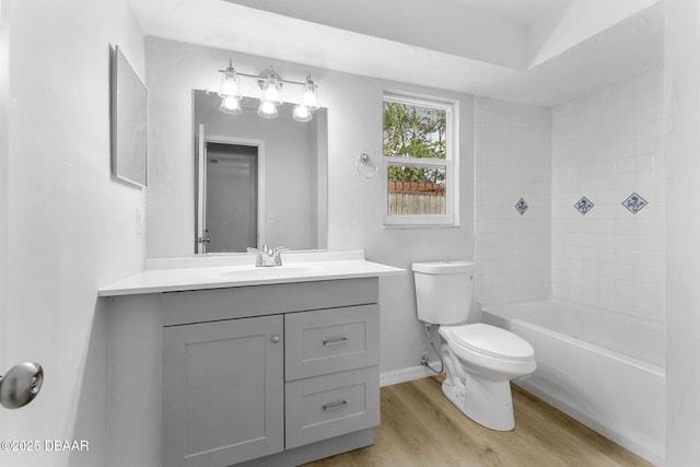full bath with vanity, baseboards, wood finished floors, and toilet