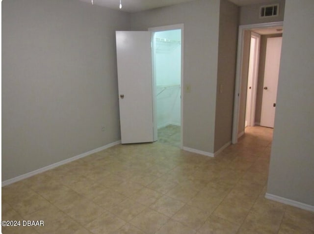 unfurnished bedroom featuring a closet and a spacious closet