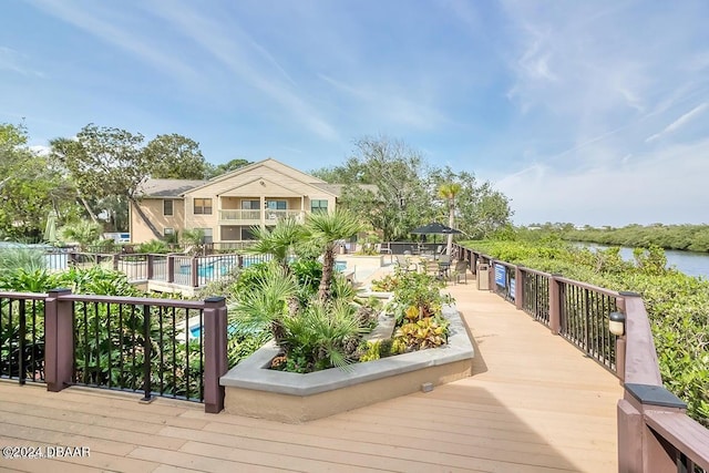 wooden deck with a community pool