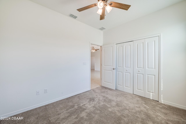 unfurnished bedroom featuring ceiling fan, a closet, and carpet floors