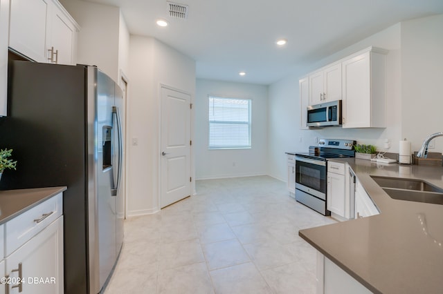 kitchen featuring white cabinetry, stainless steel appliances, and sink