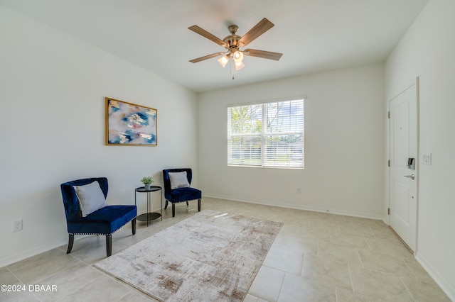 living area featuring ceiling fan and light tile patterned floors