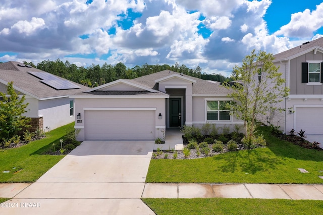 ranch-style home featuring a front lawn and a garage