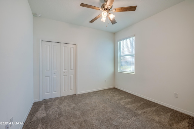 unfurnished bedroom featuring carpet, ceiling fan, and a closet