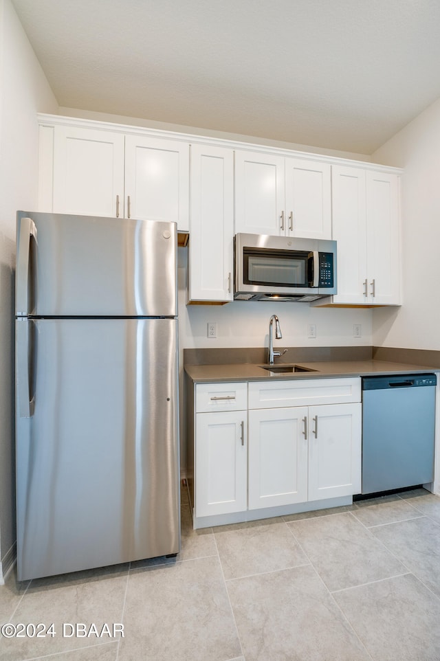 kitchen featuring white cabinetry, appliances with stainless steel finishes, and sink