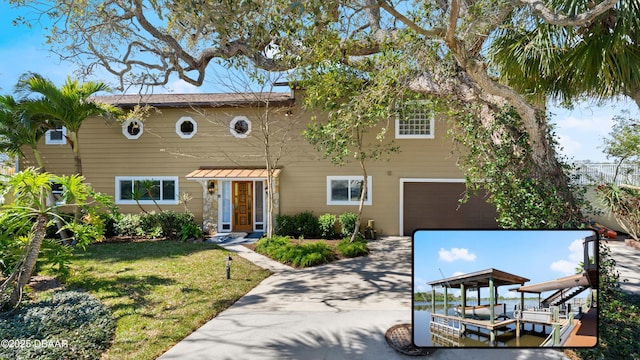 view of front of house with a garage, a front yard, and driveway