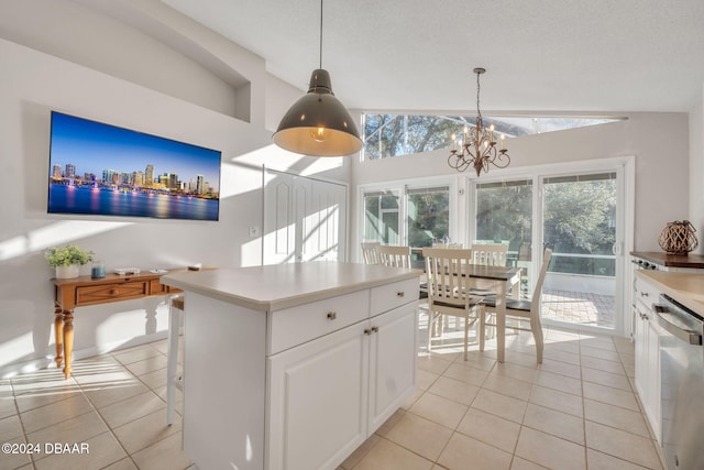 kitchen featuring white cabinetry, dishwasher, a chandelier, vaulted ceiling, and decorative light fixtures