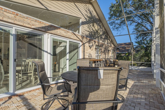 view of patio featuring a lanai