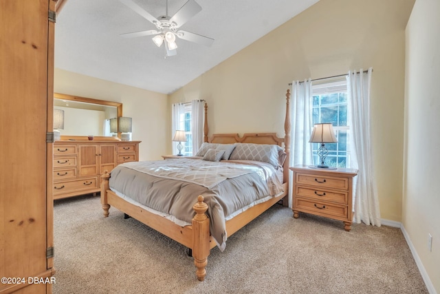 bedroom featuring ceiling fan, light colored carpet, and lofted ceiling