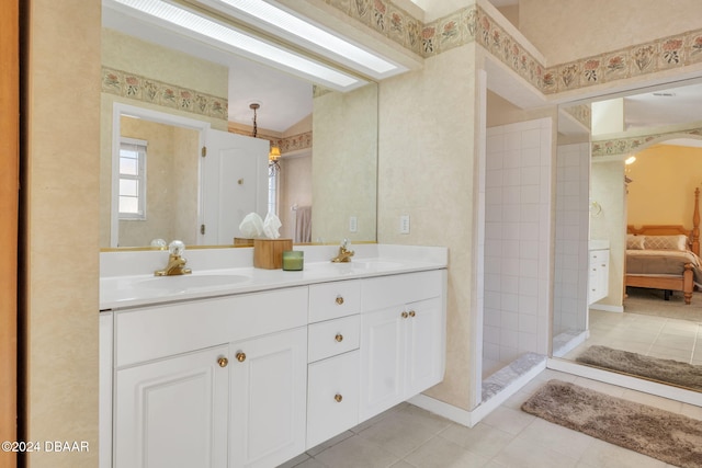 bathroom featuring tile patterned floors, vanity, and tiled shower