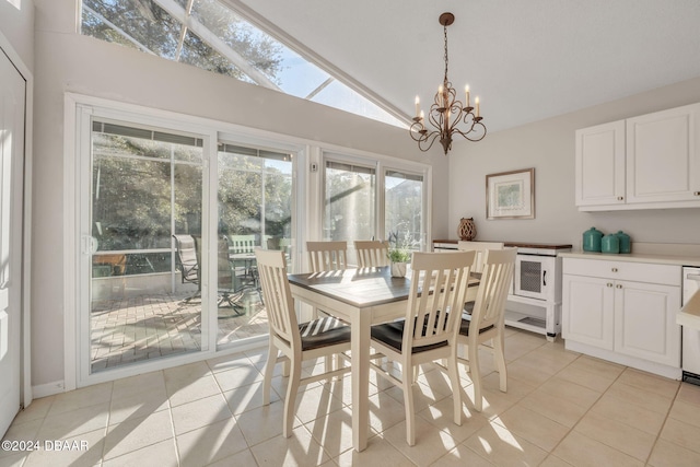 dining space featuring a notable chandelier, light tile patterned flooring, and high vaulted ceiling