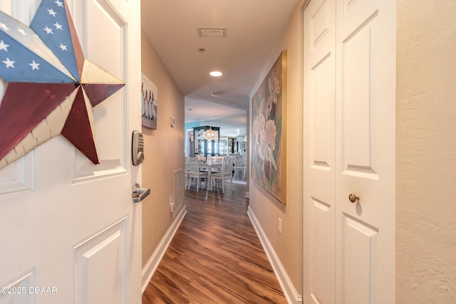 corridor with visible vents, baseboards, wood finished floors, and recessed lighting